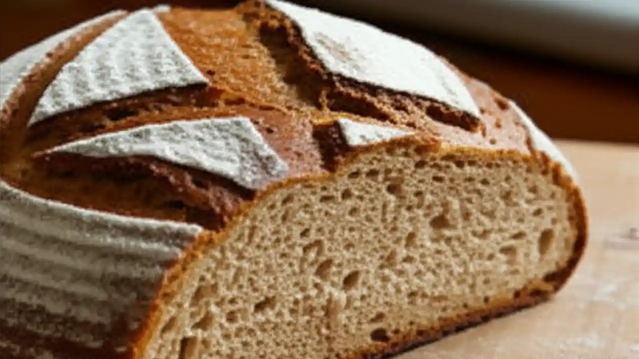 A rustic loaf of homemade whole wheat bread, sliced to show its texture, highlighting the health benefits compared to store-bought bread.