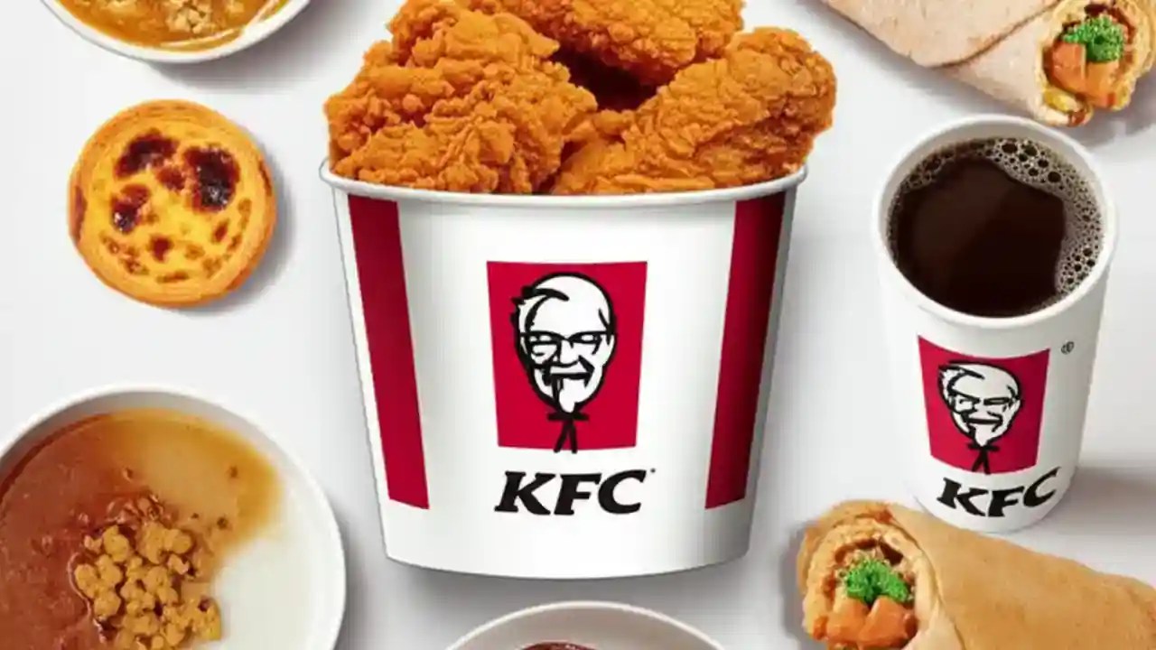 A flat lay image showing KFC China's food, including fried chicken, an egg tart, a rice bowl, a Dragon Twister wrap, and coffee.