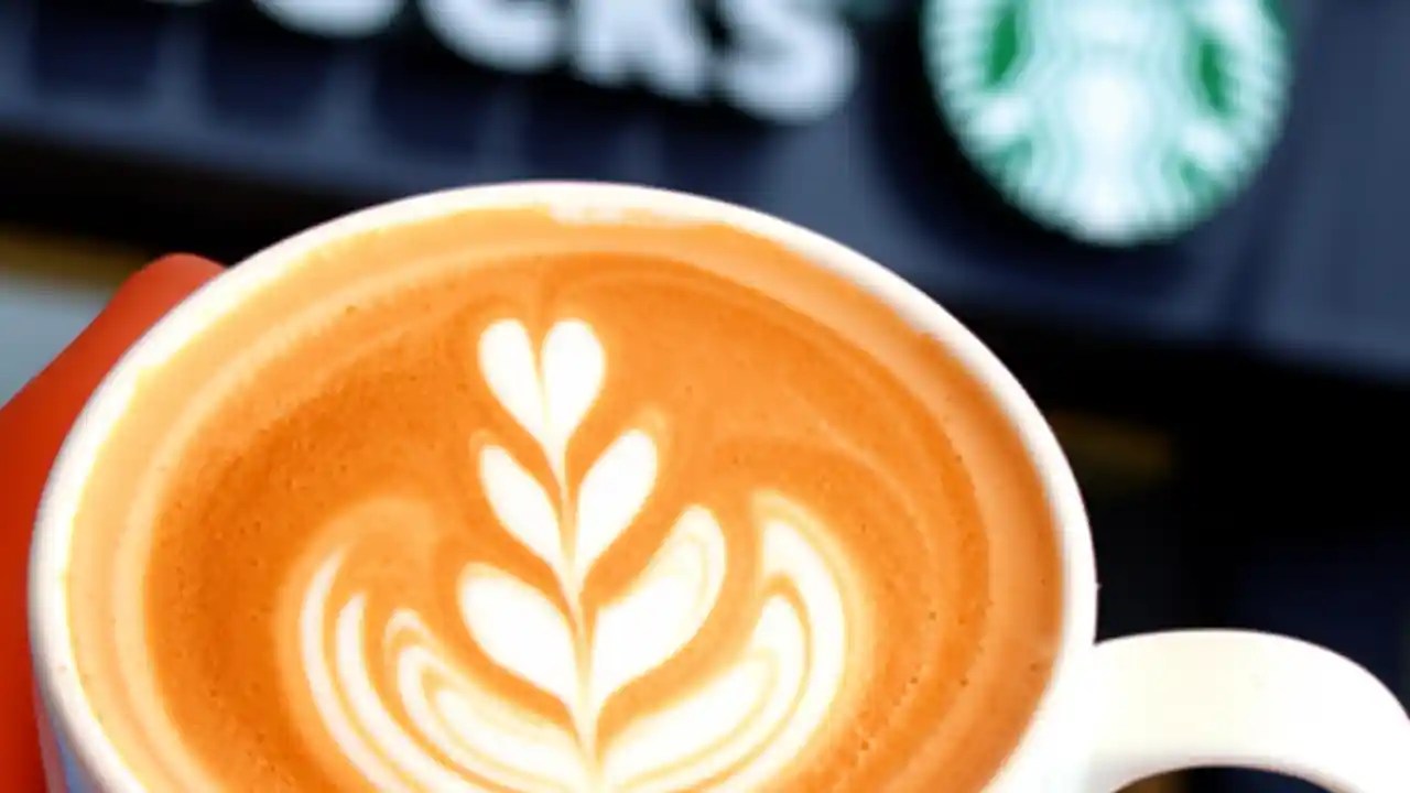 A delicious Starbucks latte in the foreground with a blurred Starbucks storefront in the background, symbolizing easy location finding.