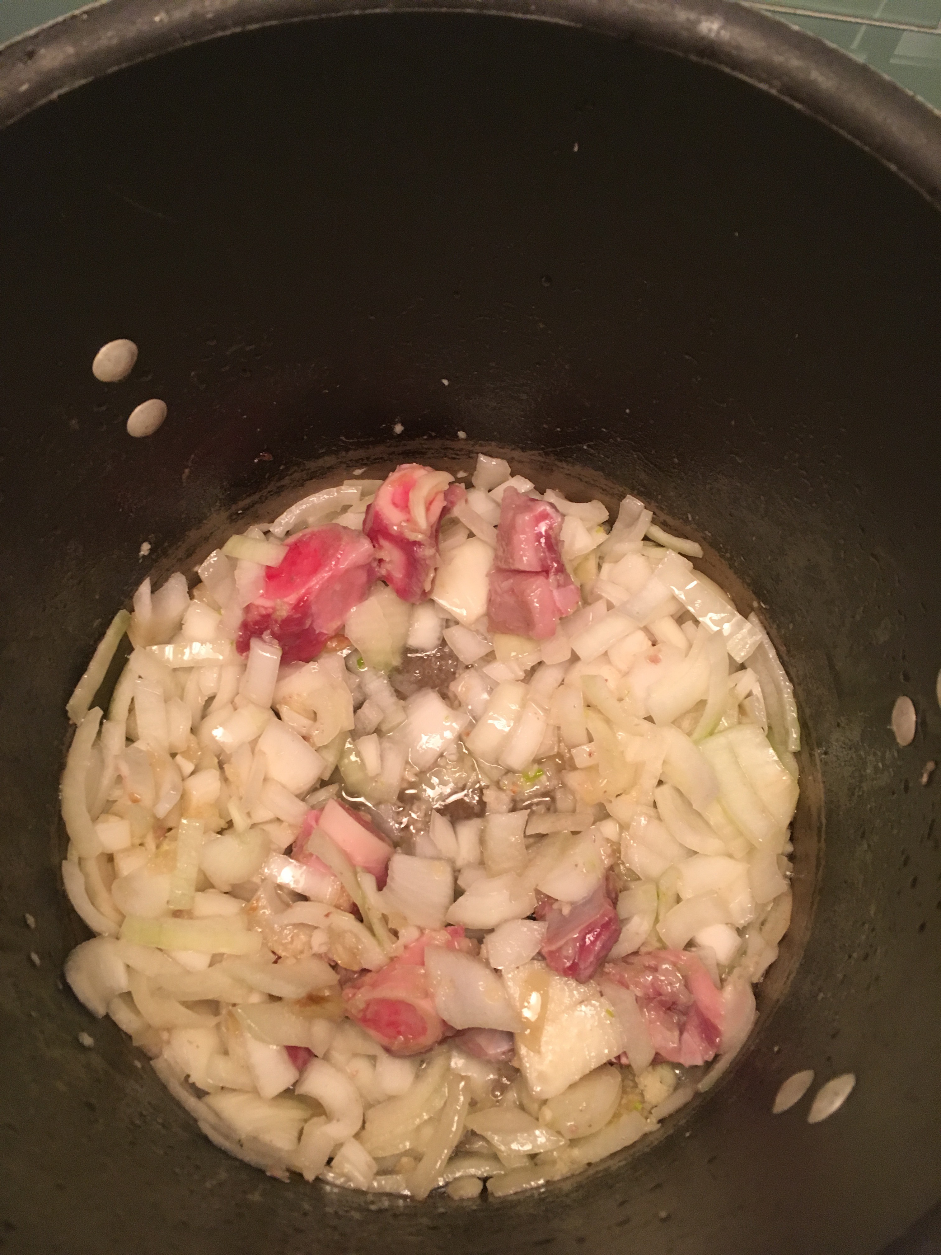 Sauteing onions, garlic, and bones in the pot