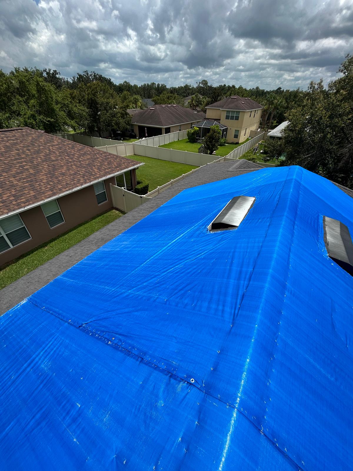 High-quality blue roof tarp installed on Florida home after storm damage