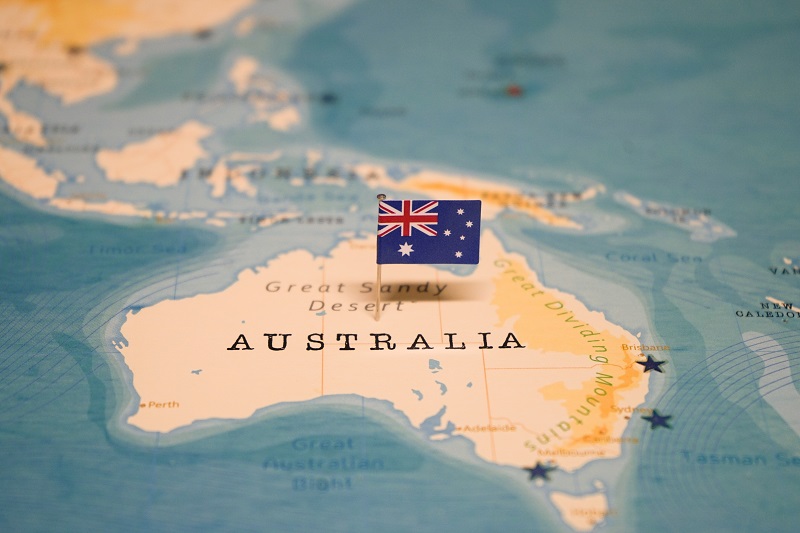 Australia’s flag over a map, representing the journey to Australian Partner Visas & Family Immigration
