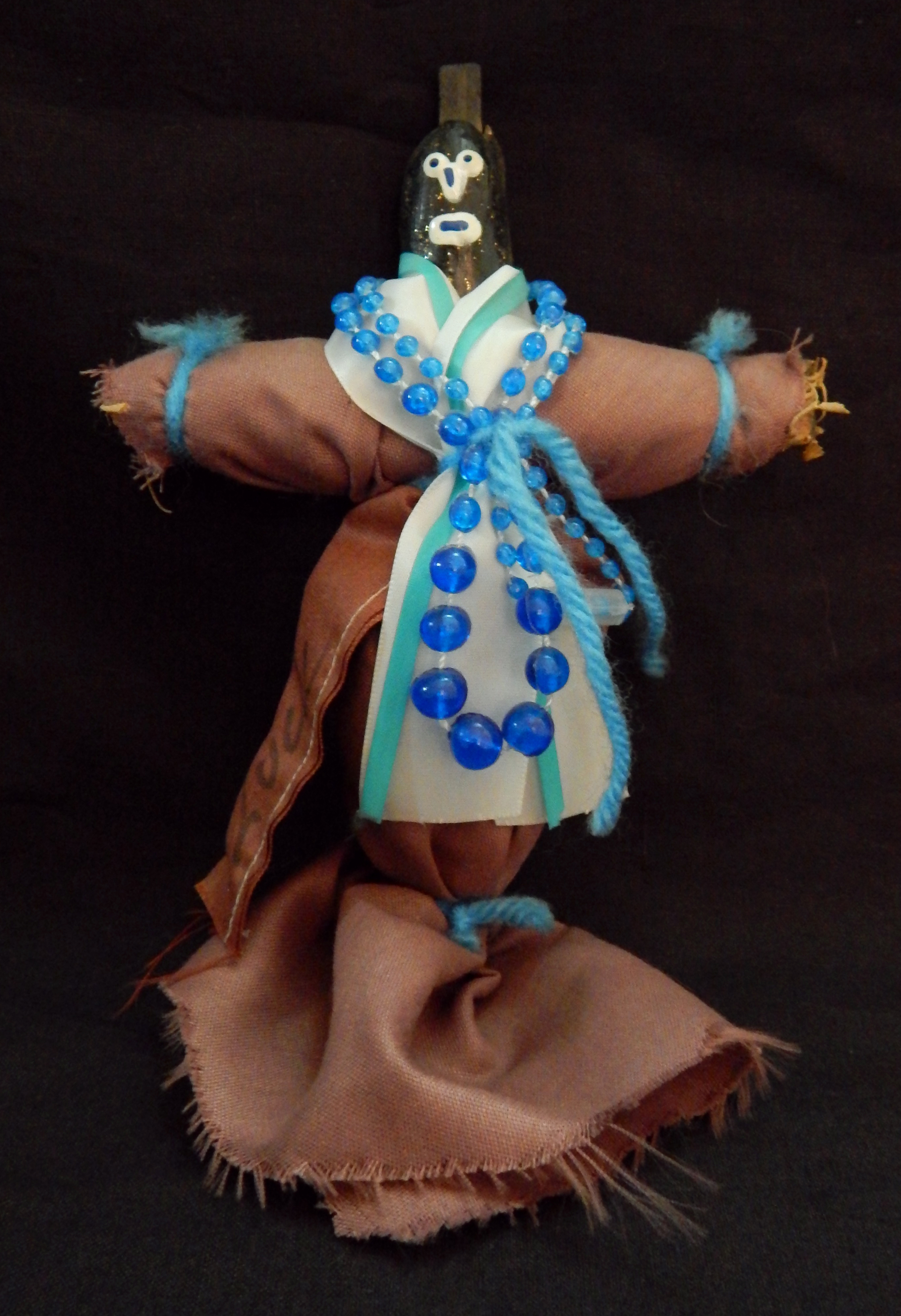 Inflicts harm on enemies, by sticking pins on the doll that represent places on enemy's body-New Orleans, Louisiana, USA/Caribbean-Afro/Carribbean-Cloth/String/Beads/Yarn-8 1/2" tall