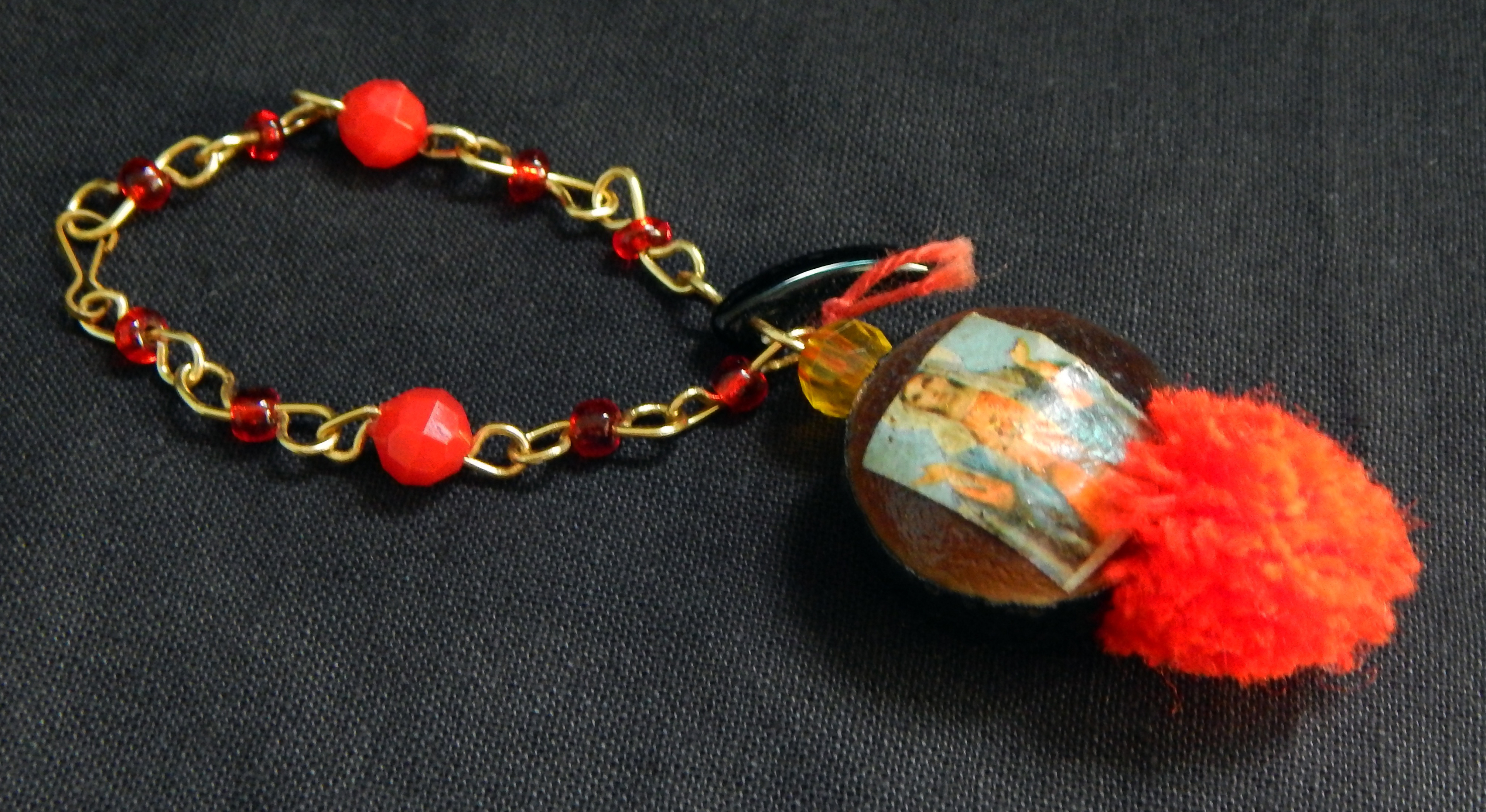 Protection and good luck-Mexico/USA-Mexican/Indigenous-Velvet bean or cowhage (Mucuna pruirens), amber bead, image of virgin, red beads, red pom poms and black horn-4" long