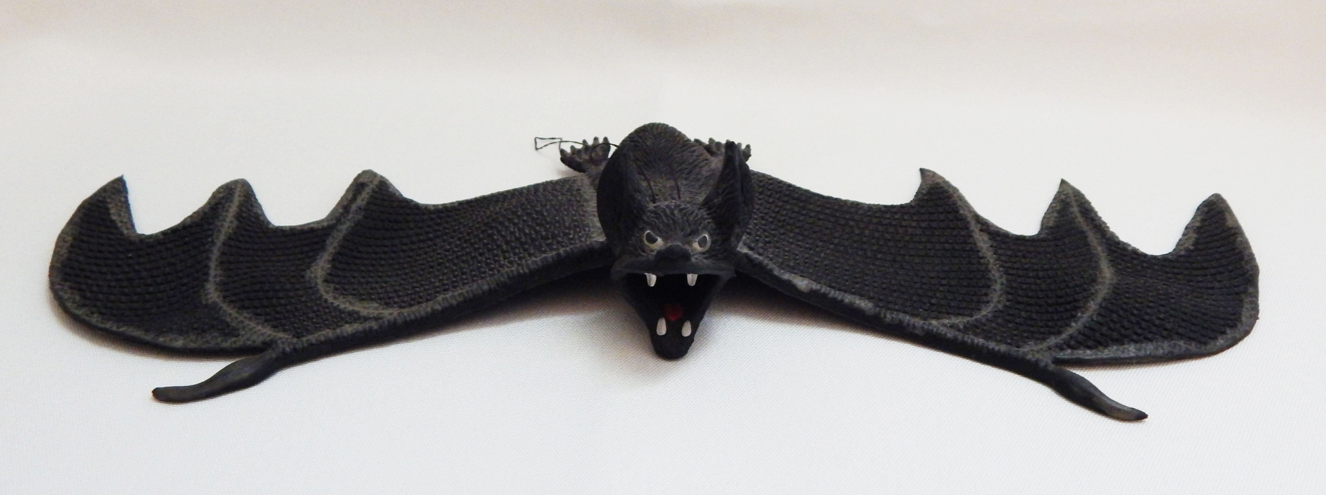 Hanging bat with teeth showing
