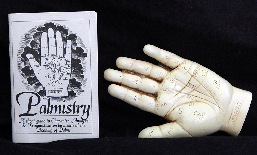 Left hand with Palmistry handbook