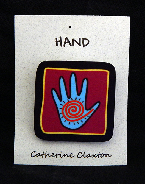 Pin with hand design with petroglyph design