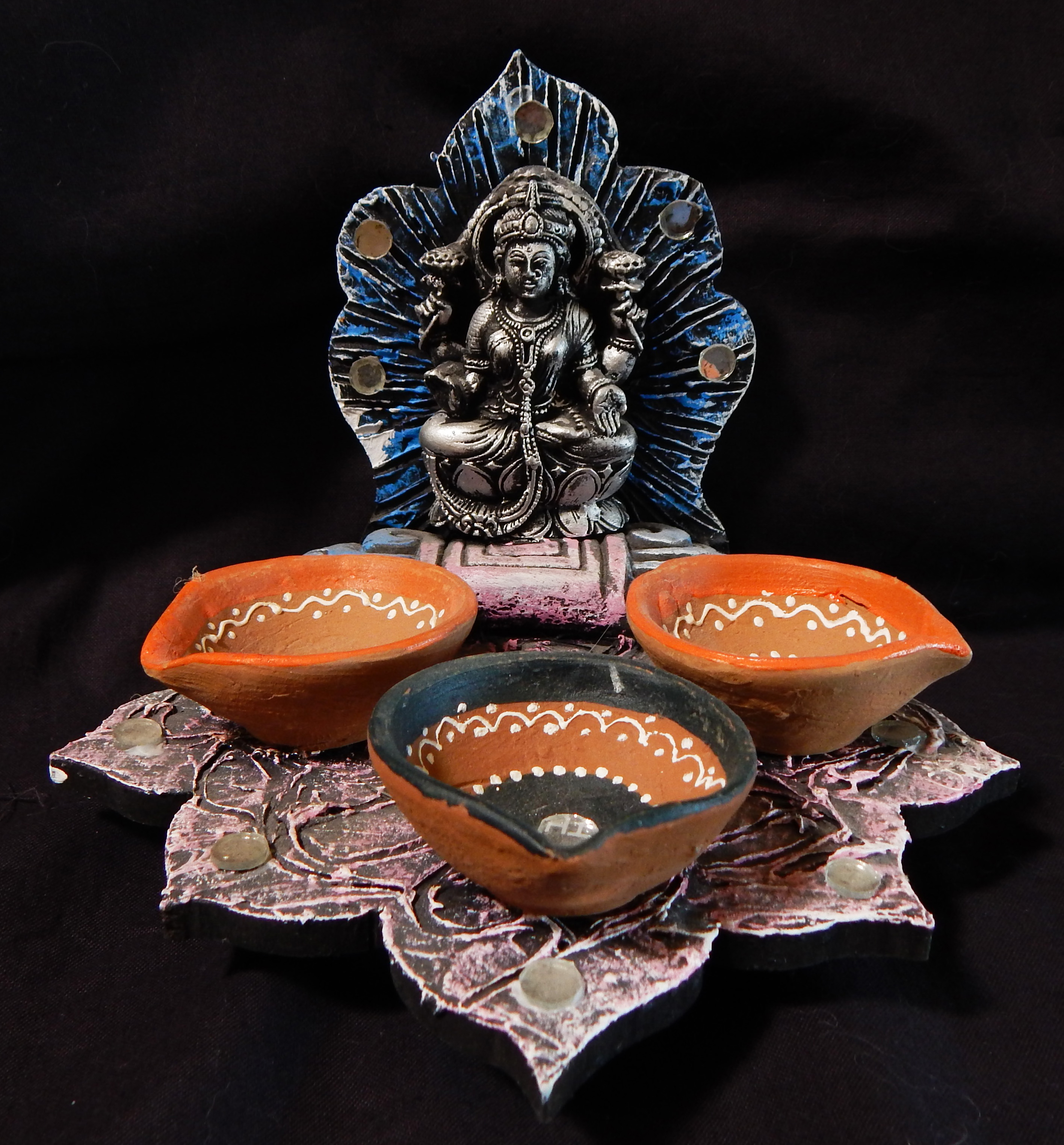 Lord Ganesha with offering bowls