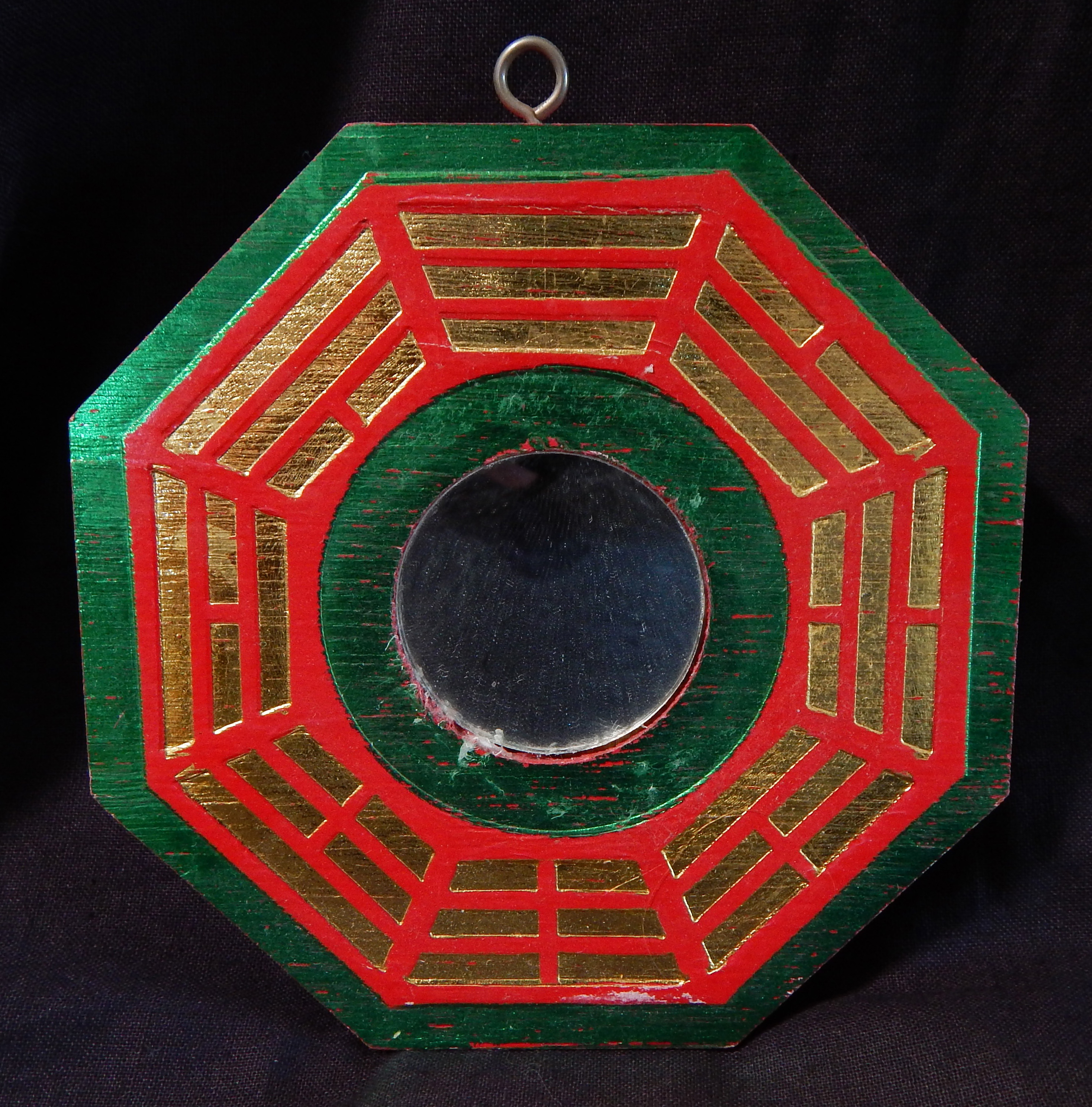 Eight sided hanging object with mirror in center (Bagua)