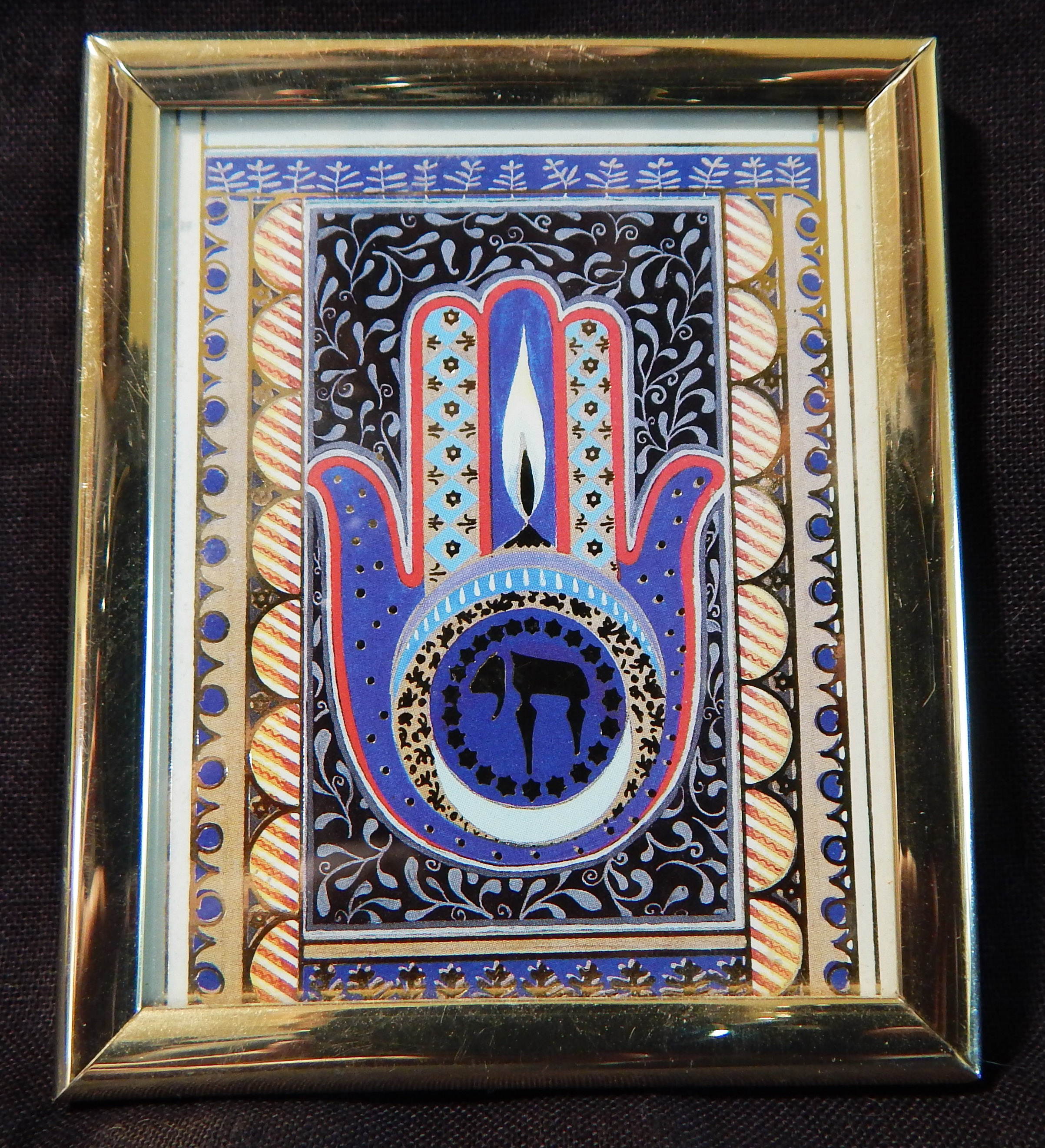 Framed picture of a hamsa with eternal flame