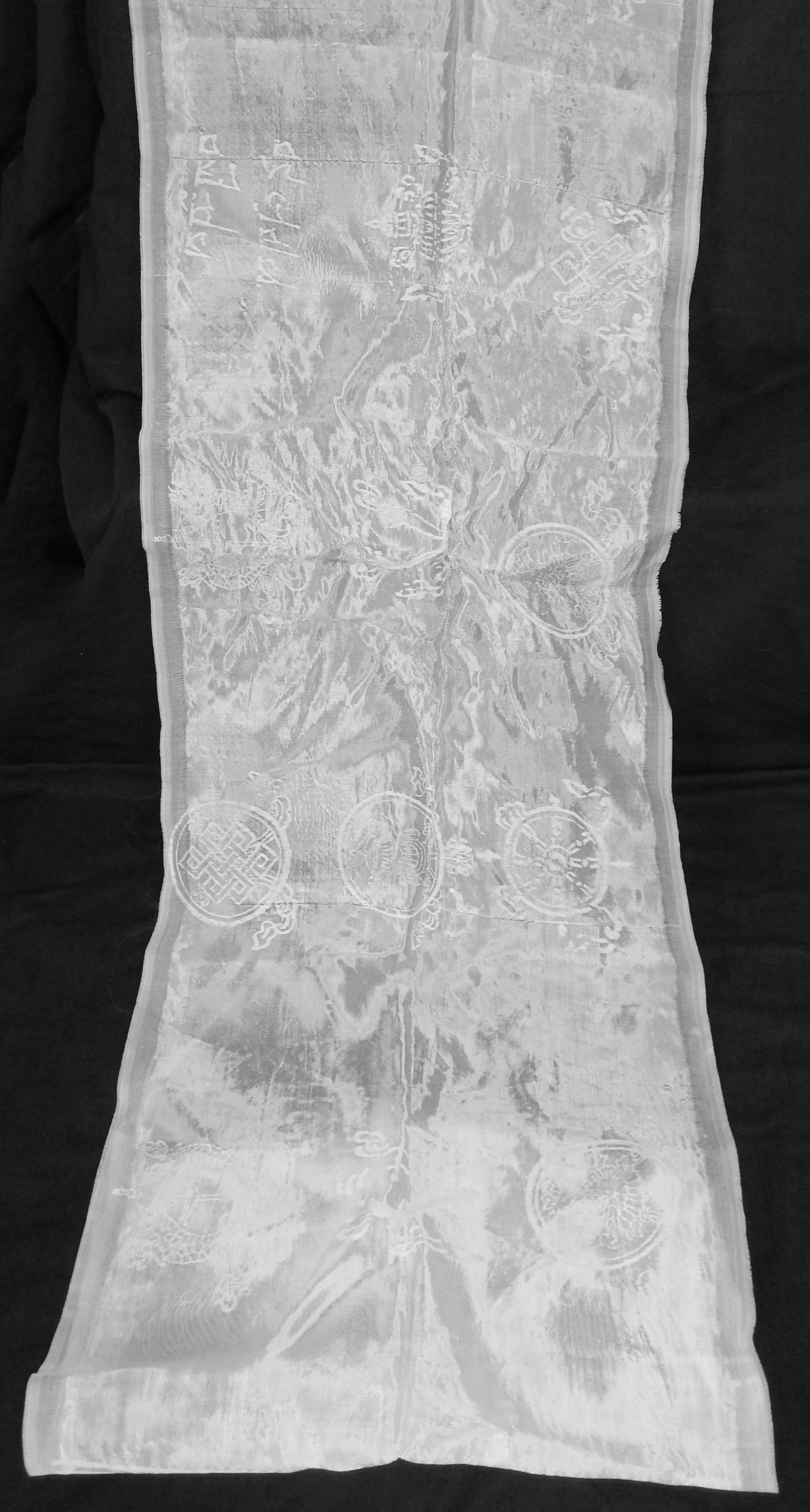 Khata (White scarf with Tibetan Eight auspicious symbols embossed upon it)