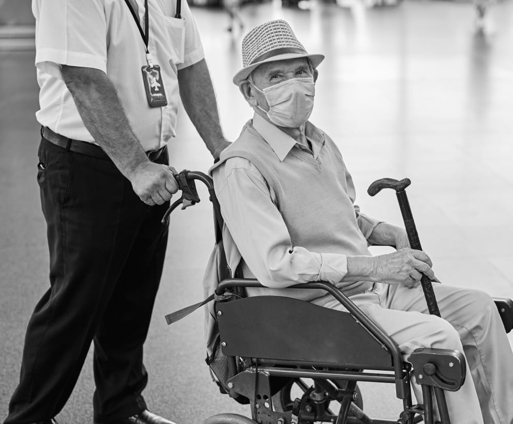 patient on a wheelchair wearing mask
