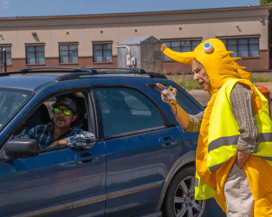 a volunteer helps direct traffic at foco comic con.