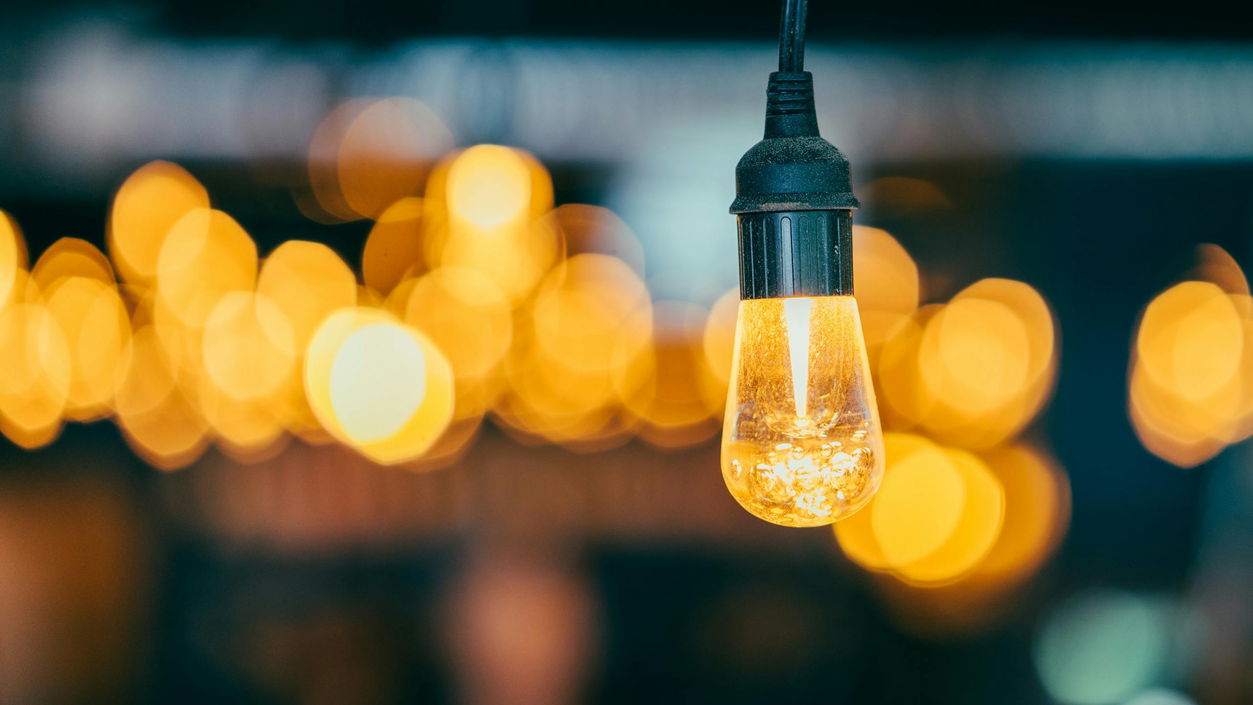 a-close-up-of-a-glowing-edison-light-bulb-against-a-bokeh-backdrop-creating-a-warm-ambient-atmospher.jpeg