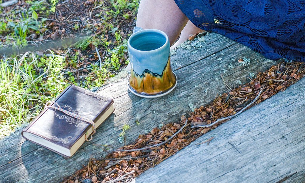 Strategy book and coffee mug next to working consultant