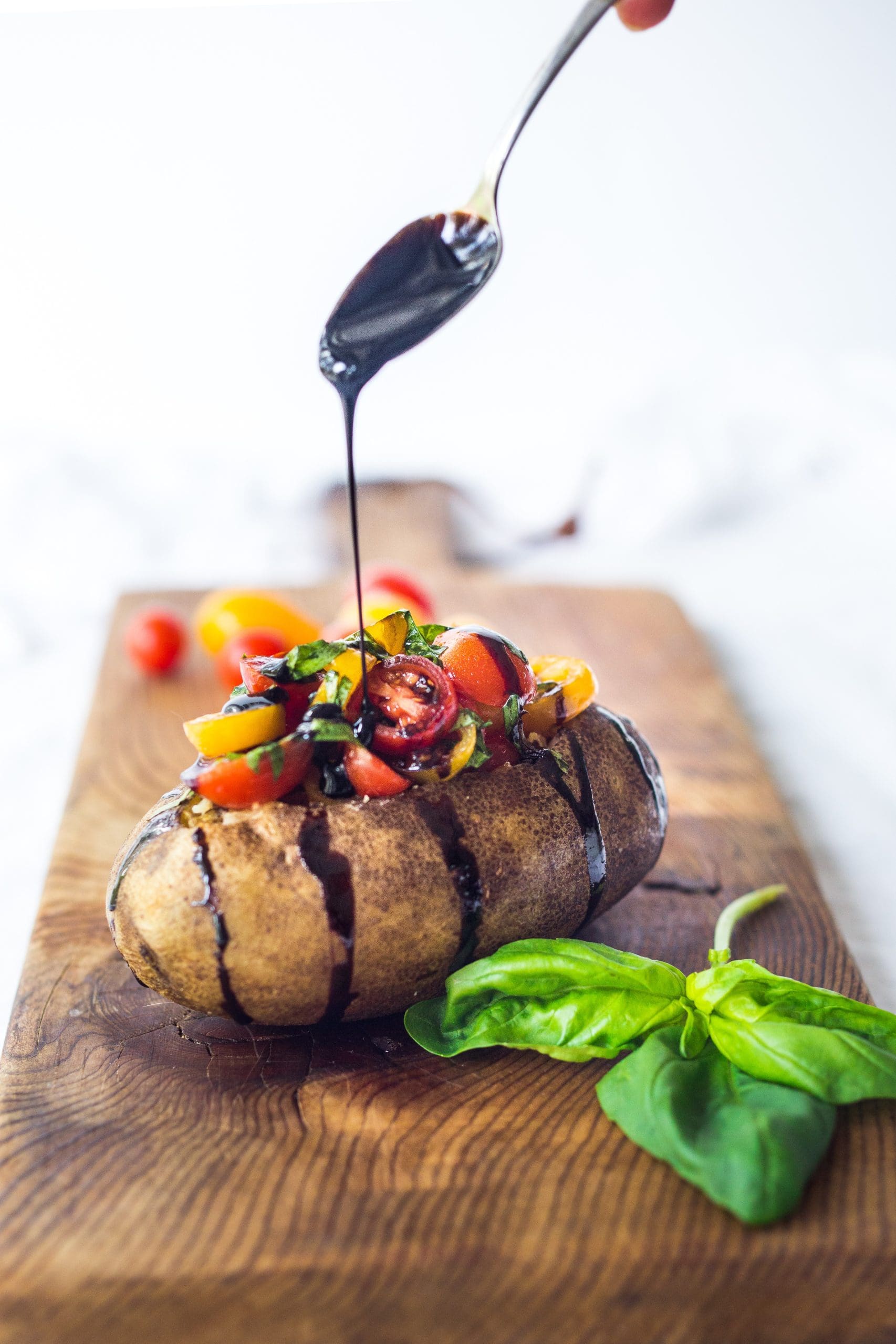 Fresh summer tomatoes and basil ribbons are tossed in a simple, but flavorful, balsamic dressing then spooned over warm baked Idaho� russet potatoes�and drizzled with a balsamic glaze. A healthy, light and delicious meal that is vegan and gluten-free!