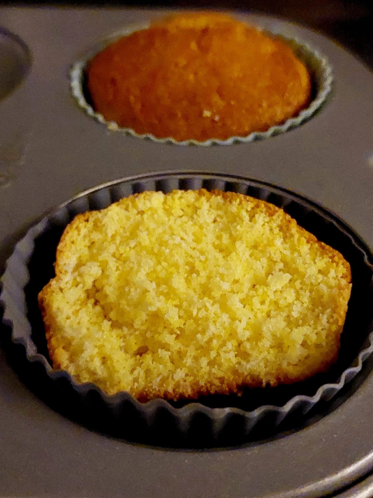 These Cornbread Breakfast Muffins are make with simple ingredients. There are two muffins one is split in the middle and in the bottom part of the photo whilst there is another full size muffin back of the split muffin.