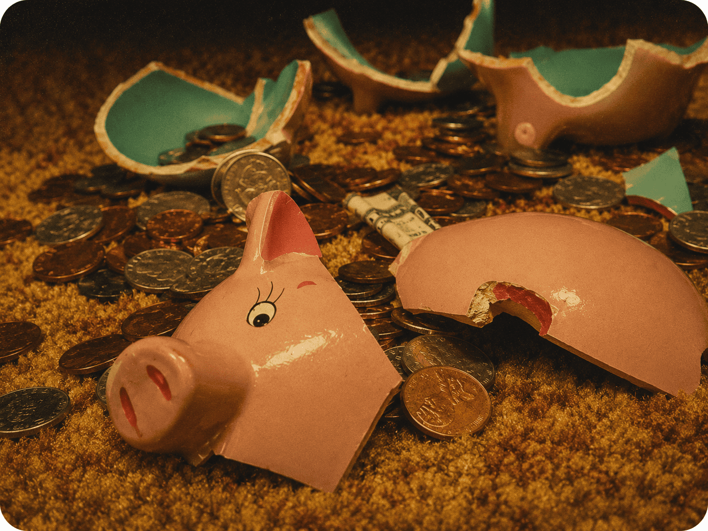 Piggy bank broken, coins spilled, symbolizing financial challenges and the need for creative problem.