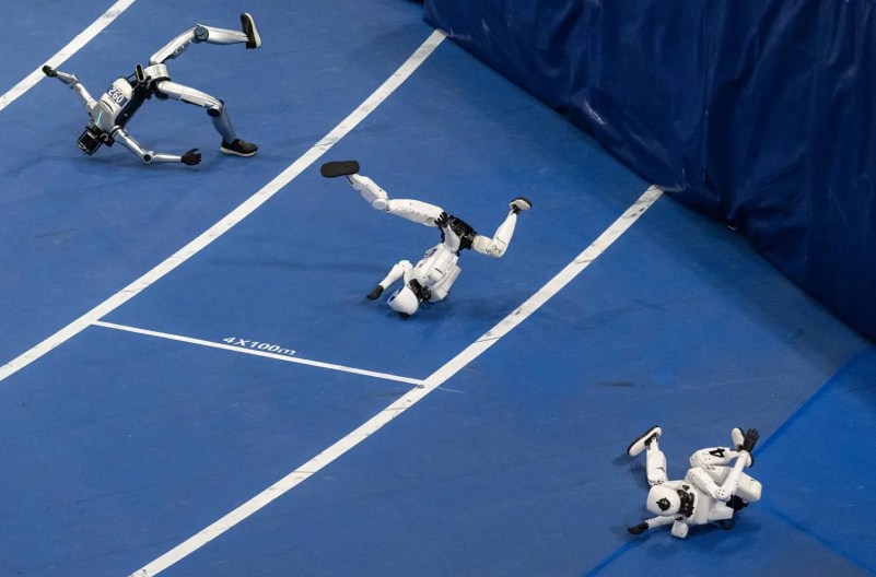 Robots are seen falling down.