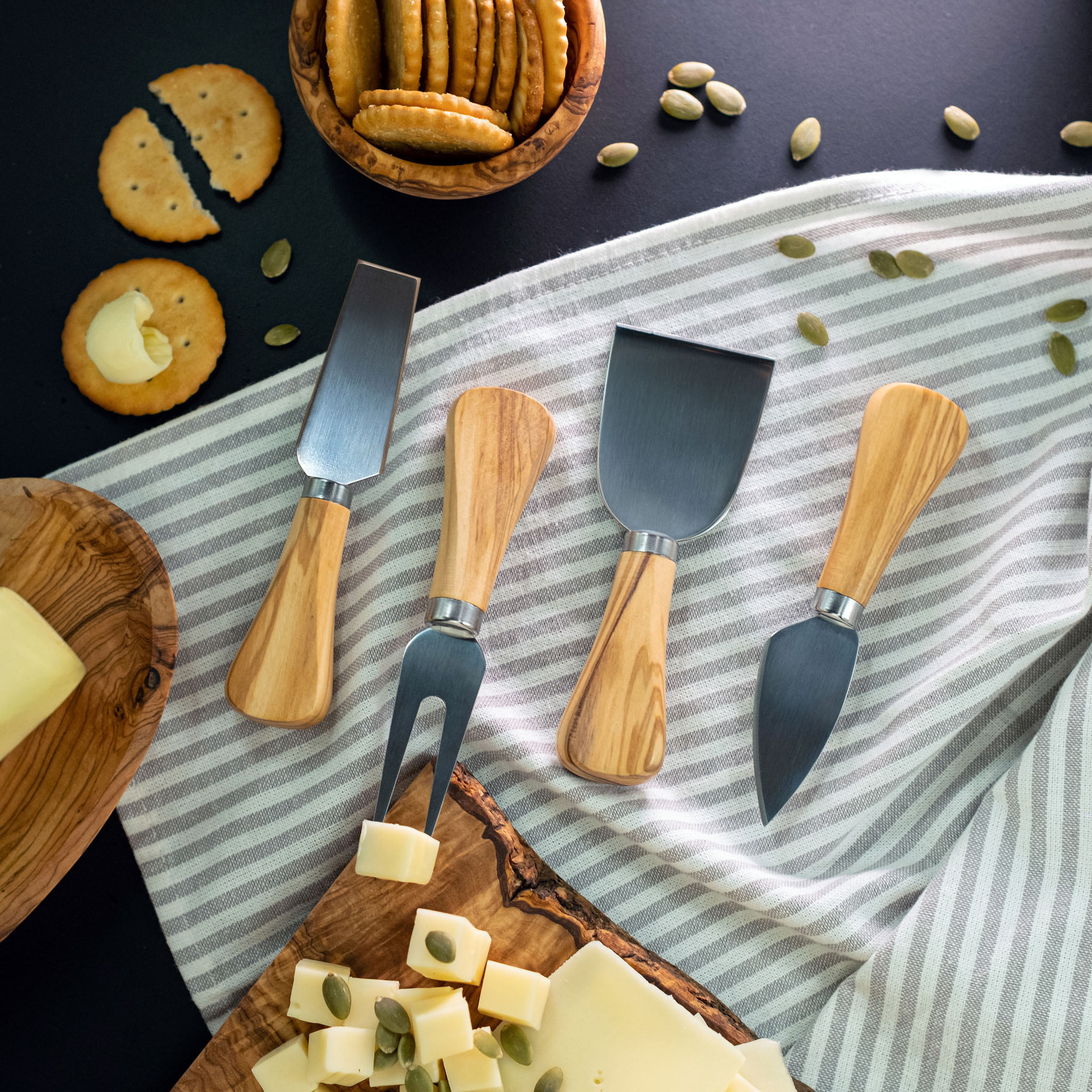 A cheese board with cheese and crackers on it.
