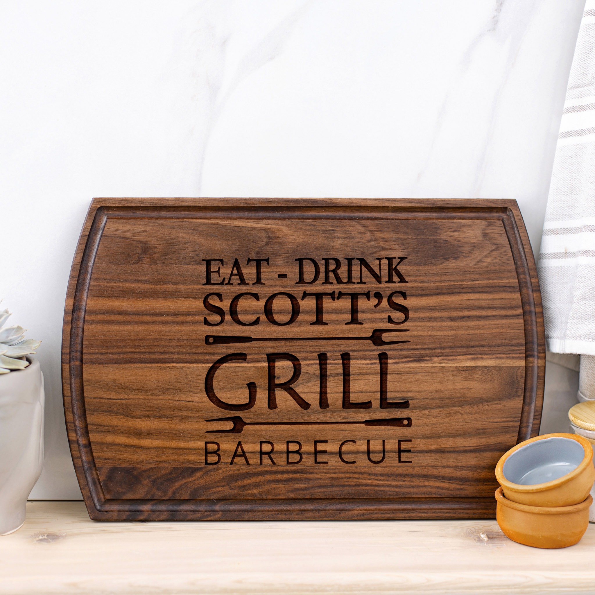 Eat drink scott's grill cutting board.