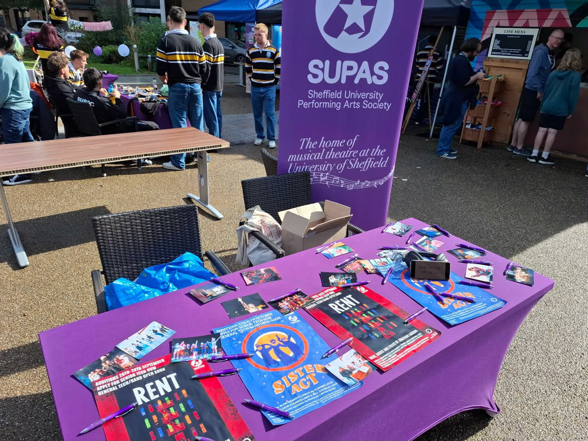 SUPAS activities fair stall with leaflets for upcoming showcases: Rent and Sister Act