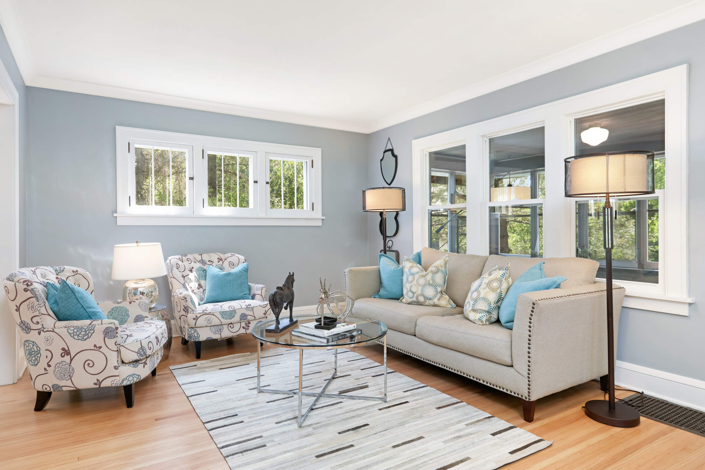 Staged living room with original windows and refinished floors, Minnetonka MN farmhouse renovation