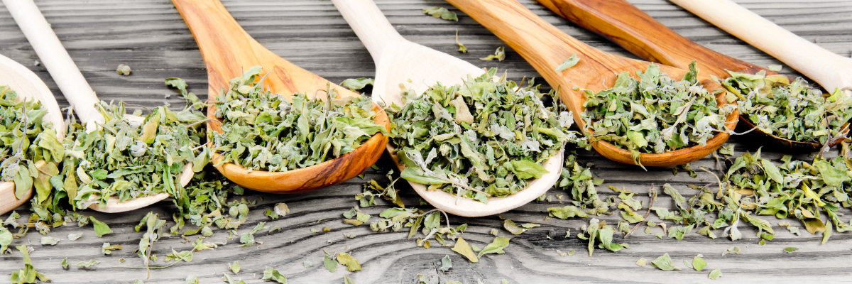 spoonful of herbs displayed on a table