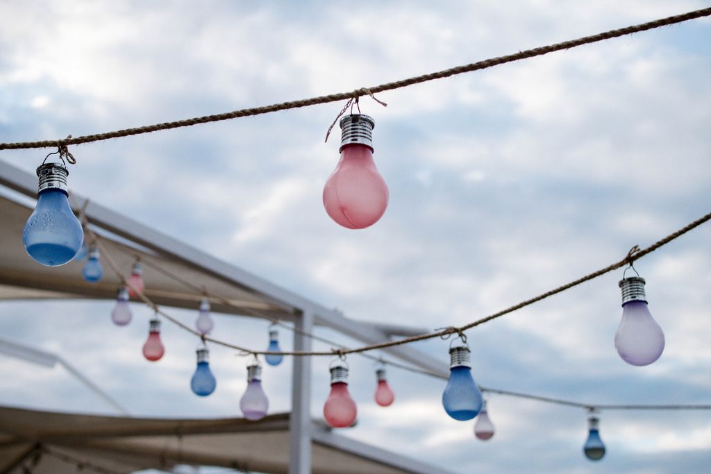 Colorful hanging lights shining across the street