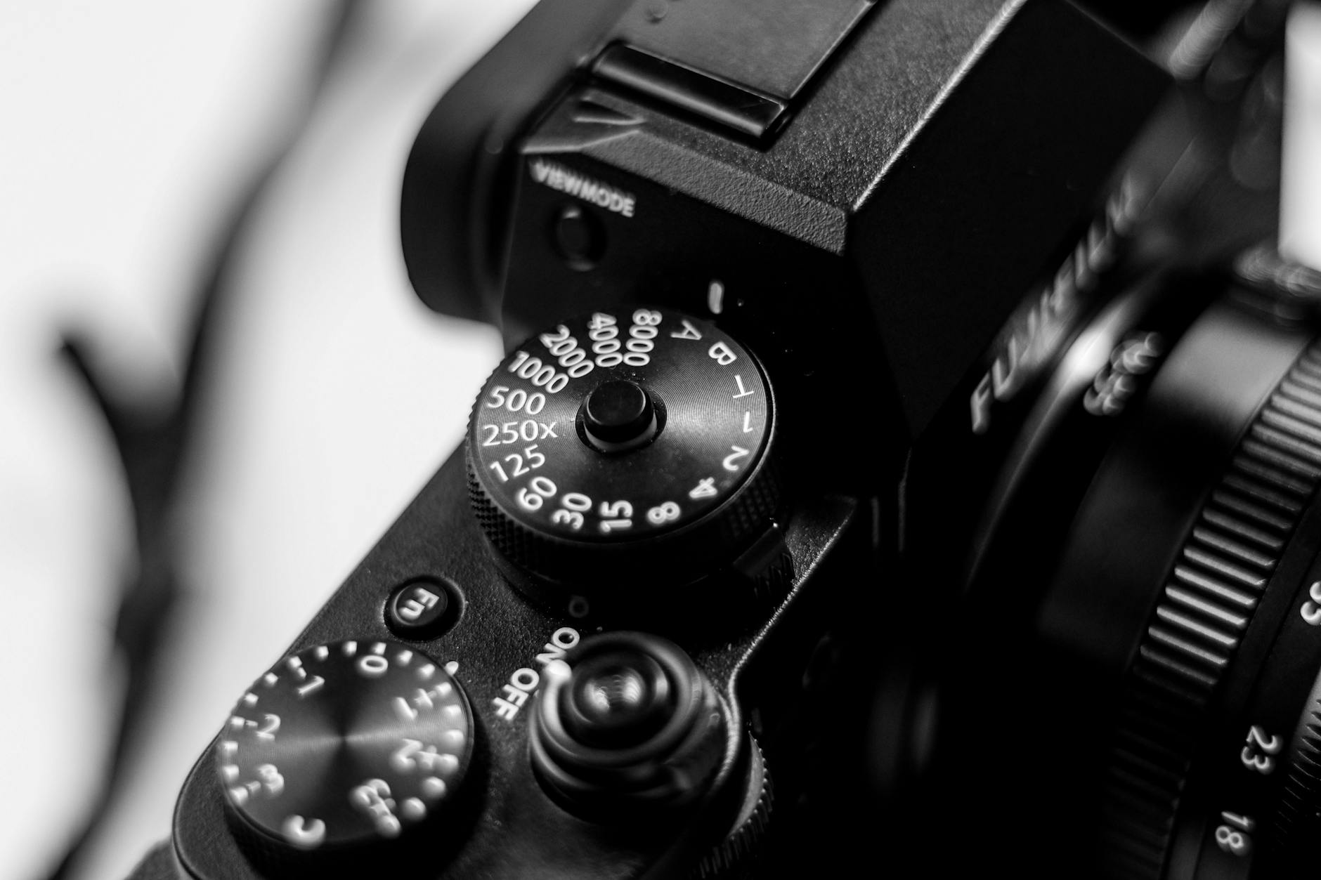 close up of camera dial on dslr in black and white