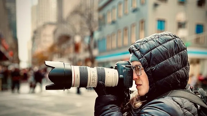 image of a photographer with a zoom lens