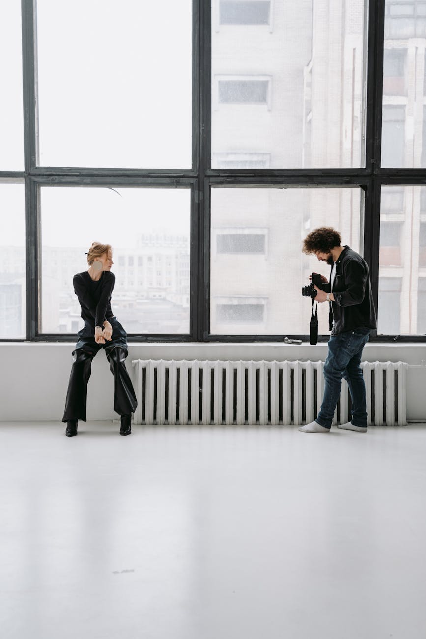 man and woman standing in front of window