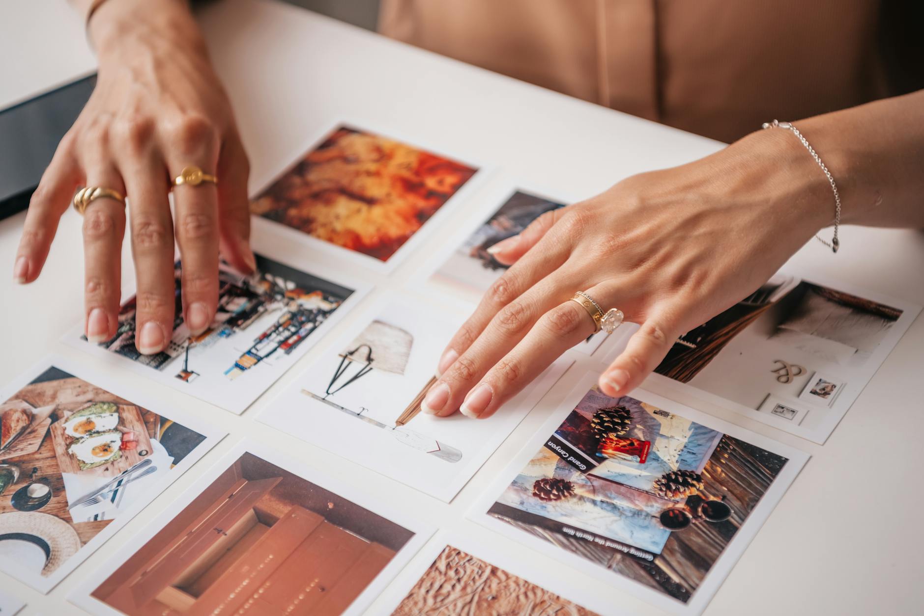 hands putting the pictures on a board