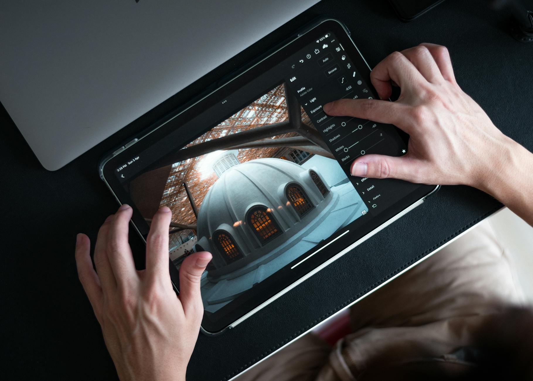 man editing a photo on ipad