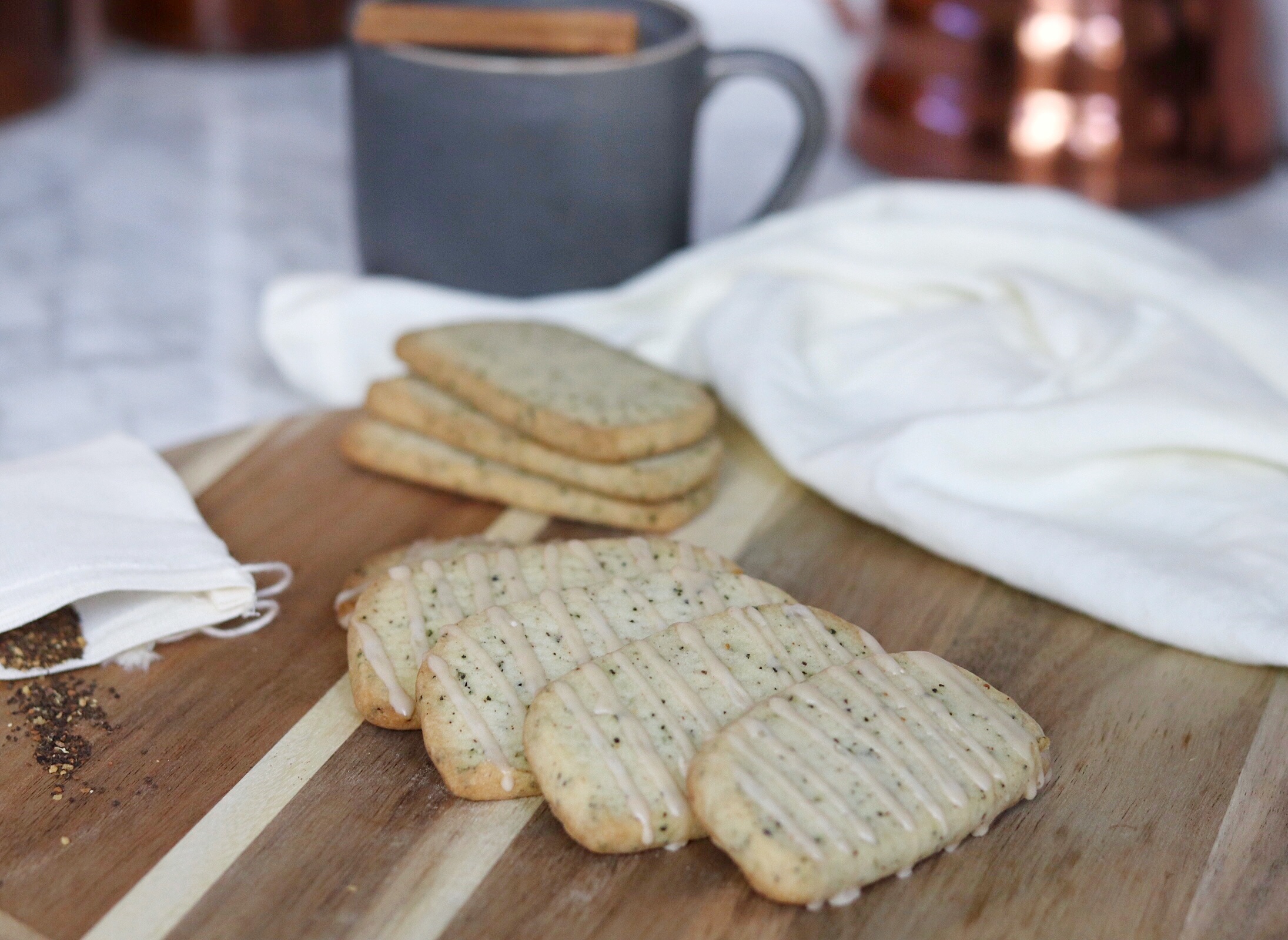 Close-up of chai-spiced shortbread cookies drizzled with vanilla cinnamon glaze