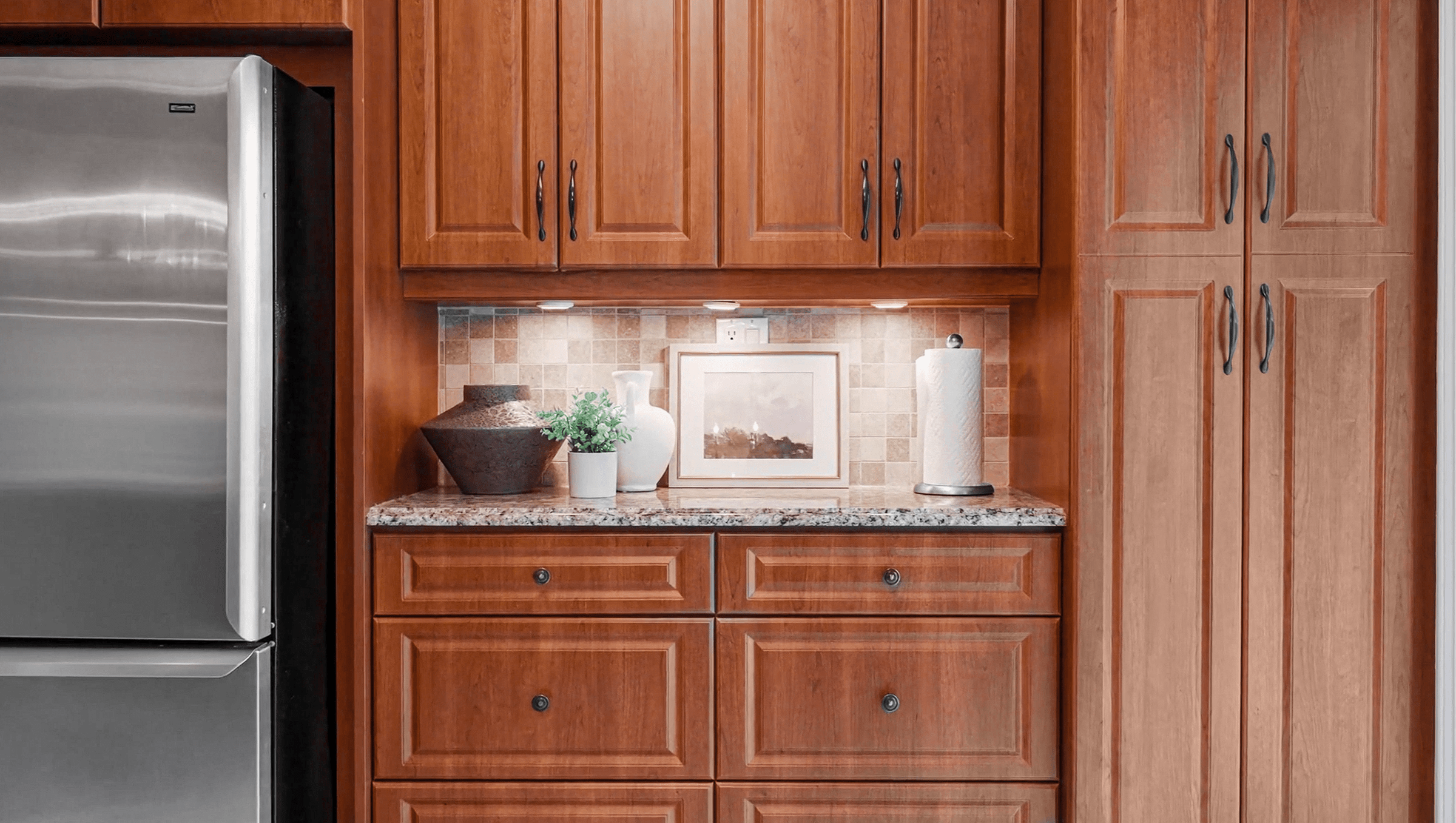 Giallo Ornamentale granite countertops paired beautifully with Bourbon Cherry coloured cabinetry.