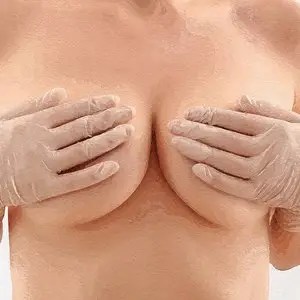 Woman covering her breasts with her hands