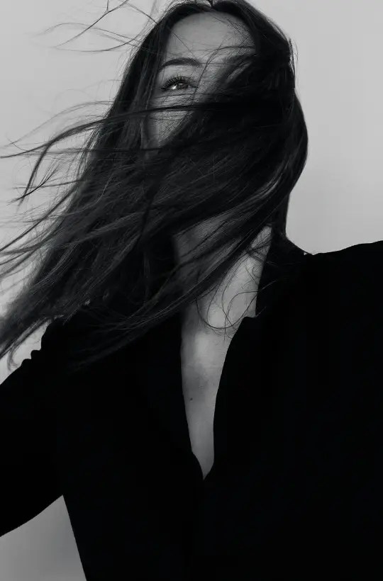 Black and white portrait of a woman with flowing hair