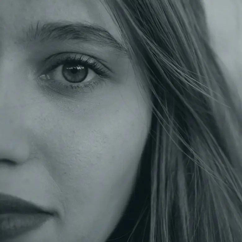Cropped photo highlighting the right half of a woman's face, emphasizing her eye