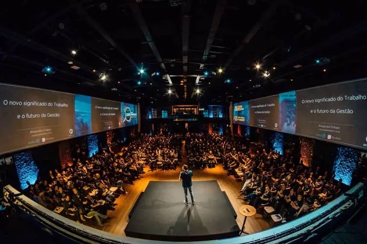 an auditorium where a man is giving a speech