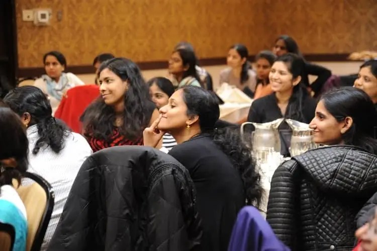 people in an audience smiling