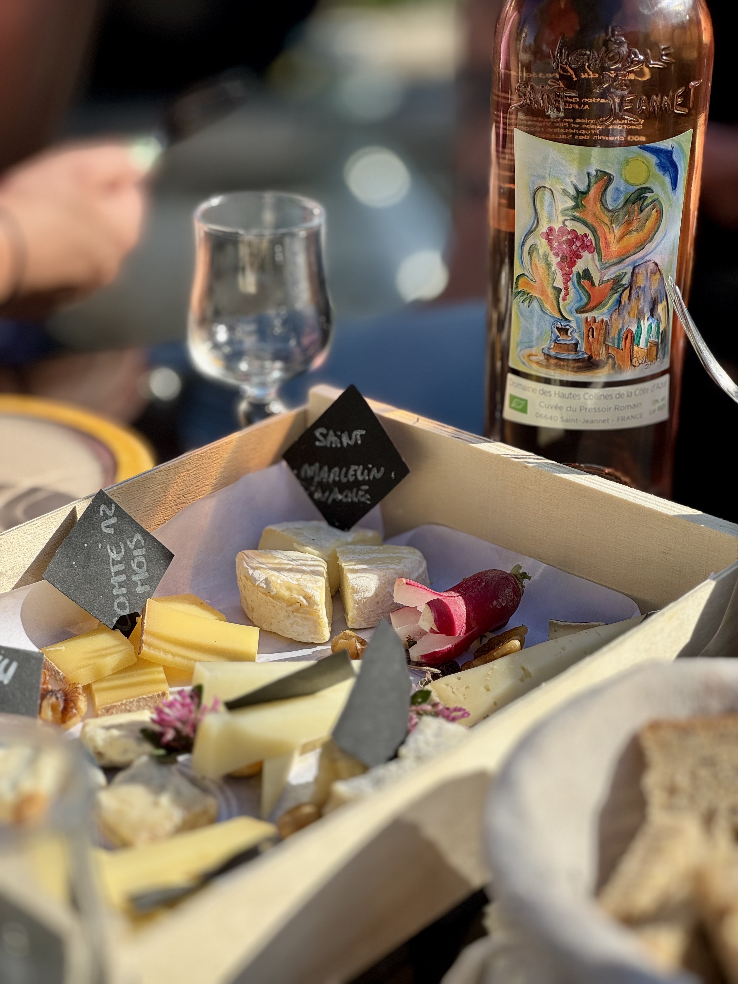 cheese and charcuterie board with wine glasses