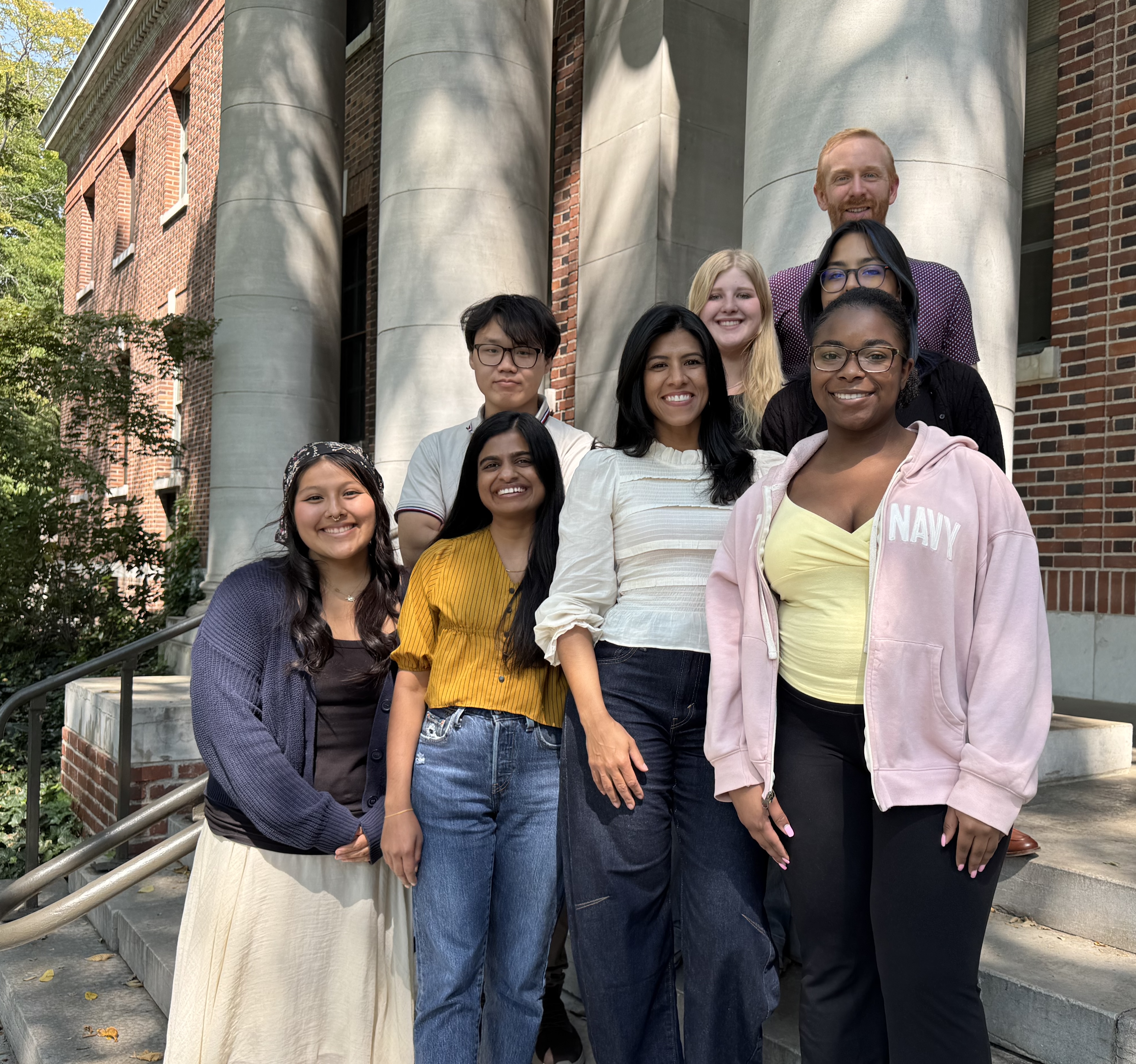 Frese Lab team members standing together outside a campus building