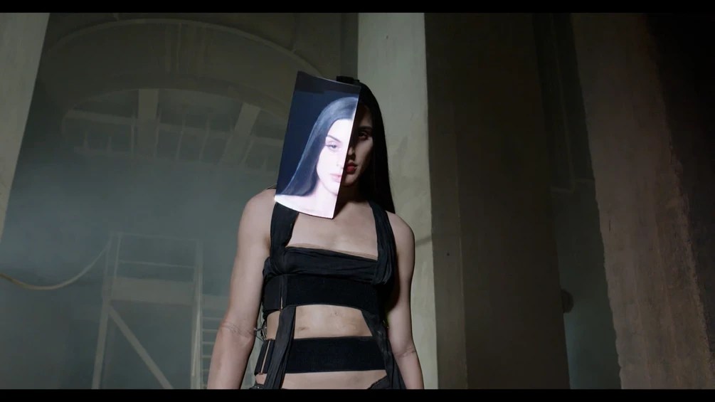 Arca performing in an abandoned warehouse