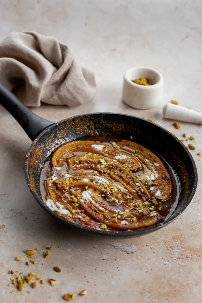 Caramelized miso bananas in a skillet, golden and glazed