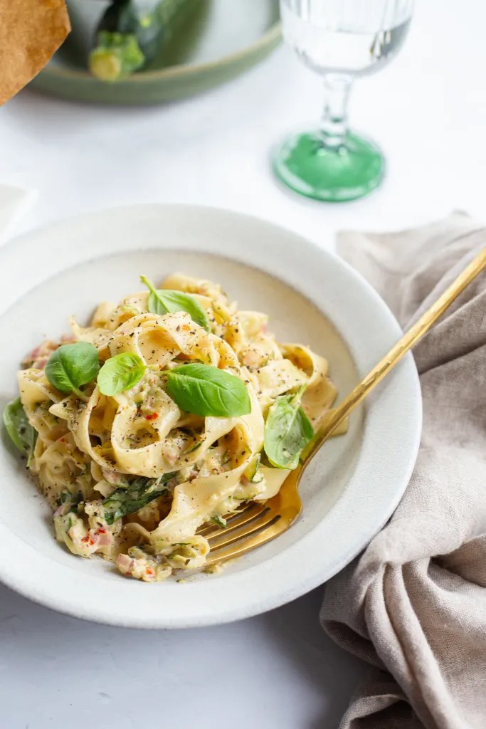 Creamy Zucchini Pasta served in a bowl and topped with fresh basil, and black pepper.