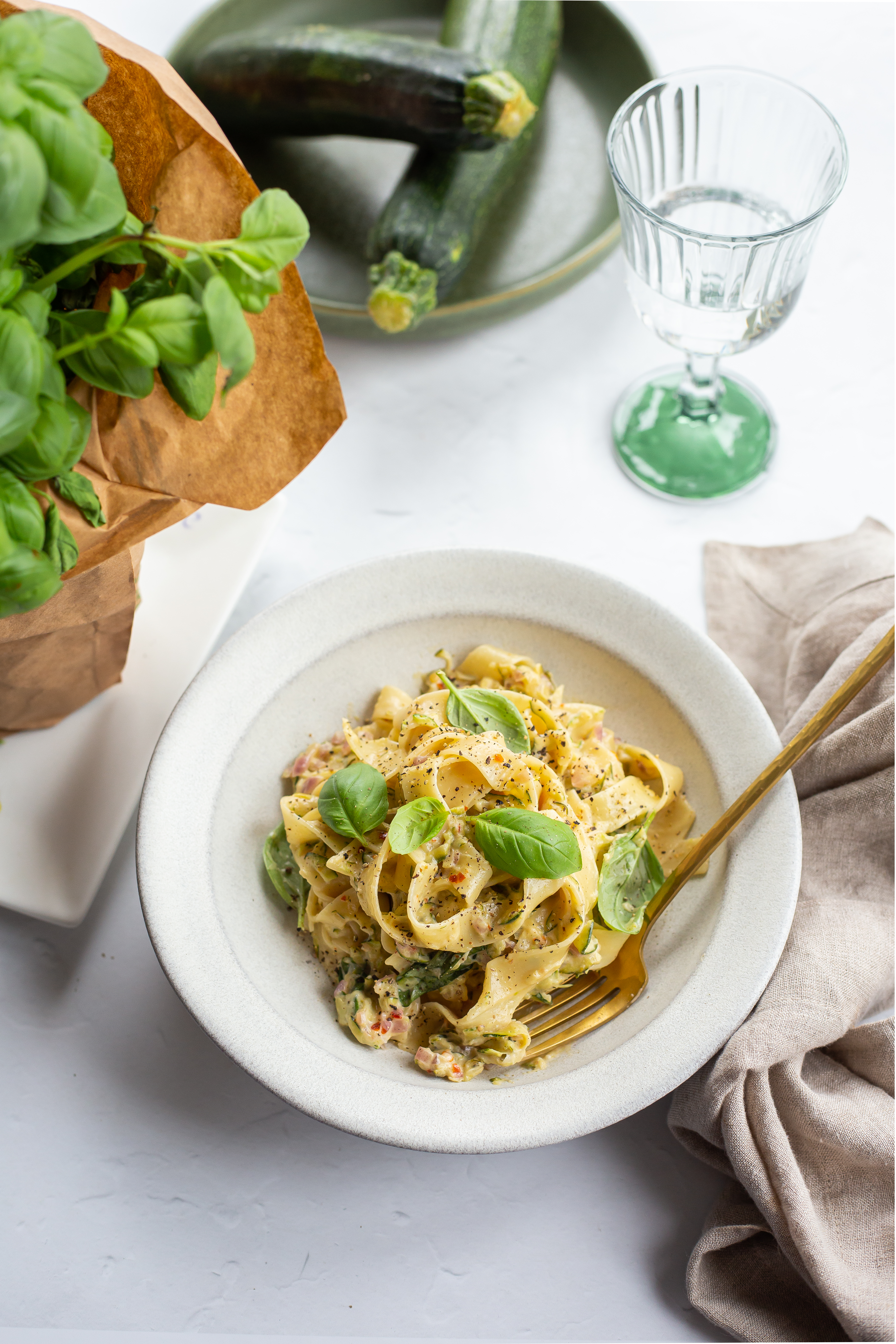 Creamy Zucchini Pasta served in a bowl and topped with fresh basil, and black pepper.