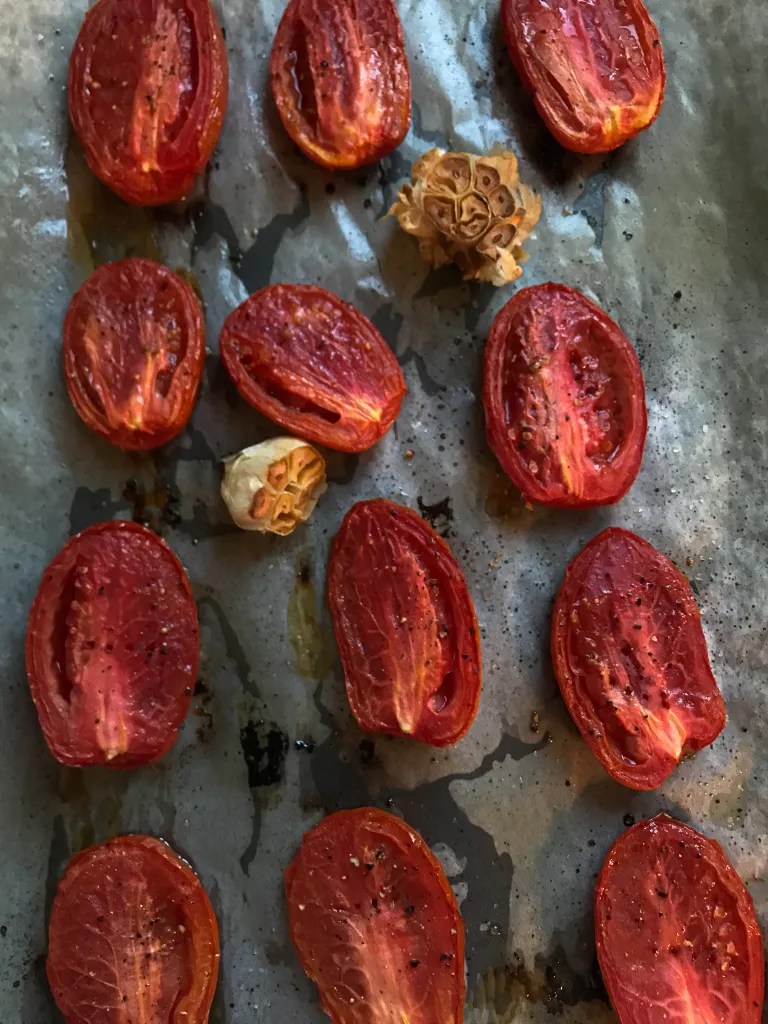 roasted tomato halves on a sheet pan right out of the oven