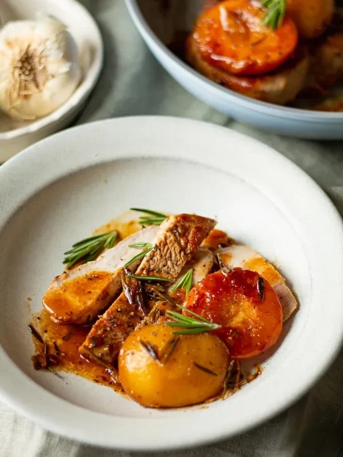 pork chops topped with caramelized peaches and rosemary