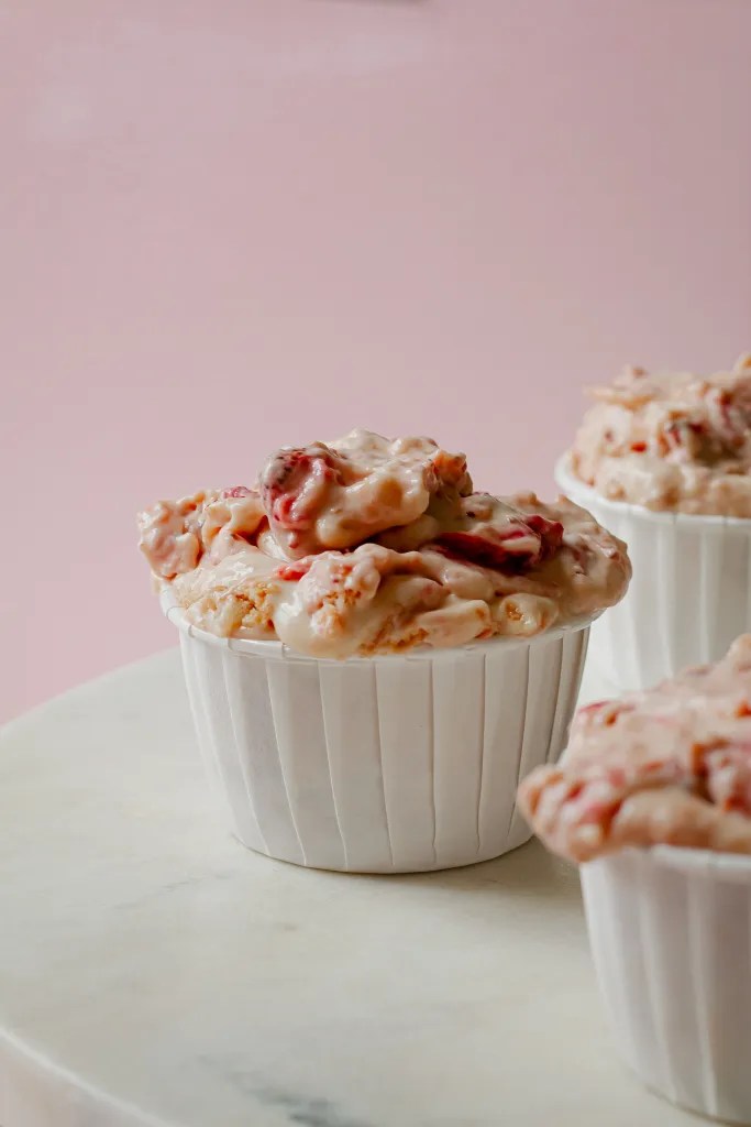 Strawberry shortcake pudding cups topped with roasted strawberries and crushed vanilla wafers